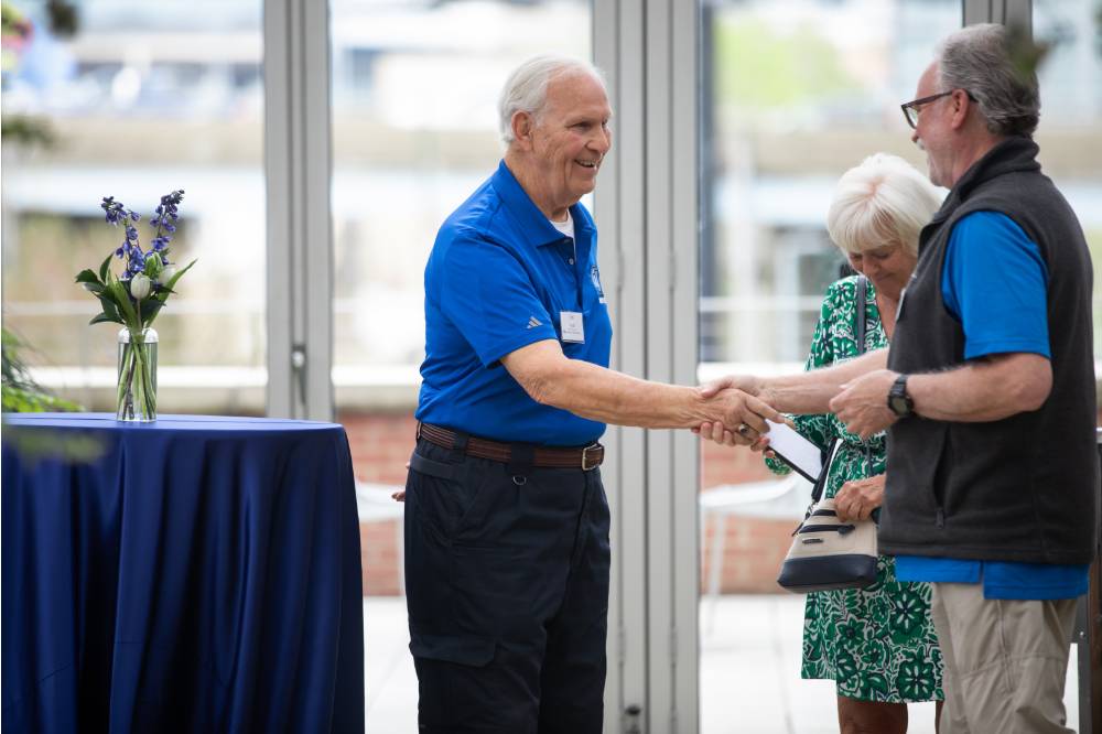 Jim Scott shaking hands with male coworker